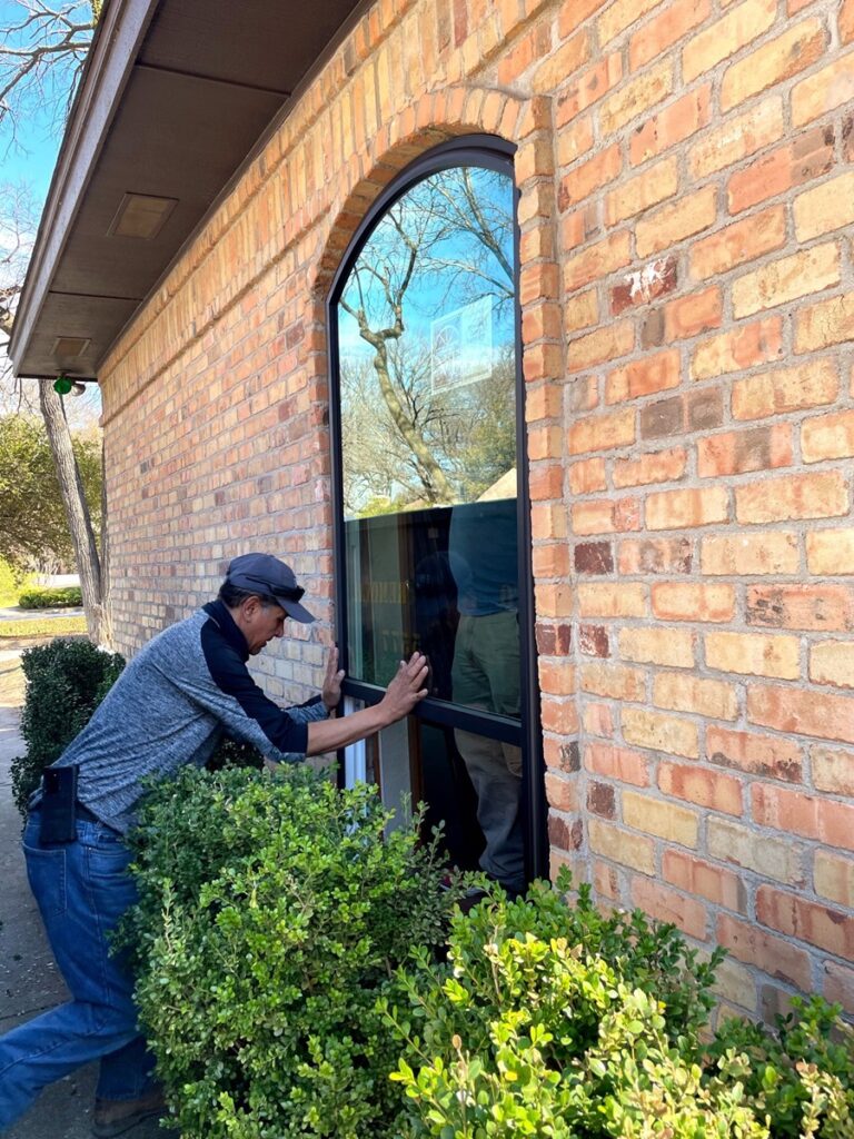 A-man-installing-energy-efficient-picture-replacement-windows-in-Coral-Gables-FL